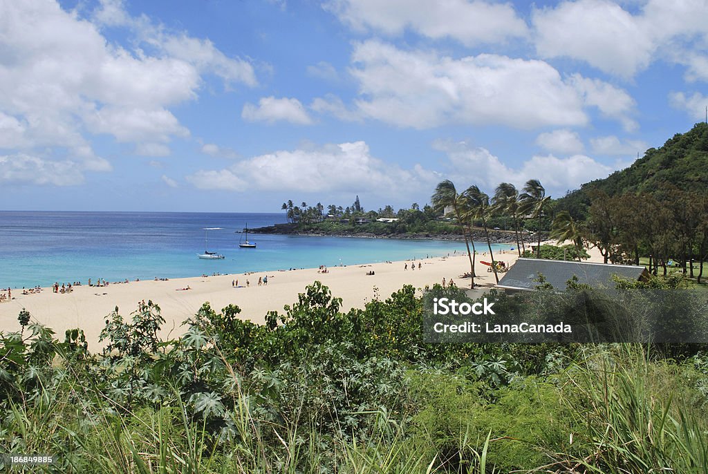 Waimea Bay Beach Park, North Shore Oahu Waimea Bay Beach Park is located on Oahu's North Shore. During the summer months the water of this bay is calm and great for swimming with a large sandy beach area. Waimea Falls Stock Photo