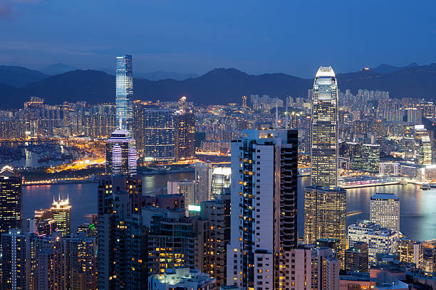 Hong Kong Skyline "Hong Kong skyline at dusk, Victoria Harbor is famous for spectacular panoramic views." international commerce center stock pictures, royalty-free photos & images