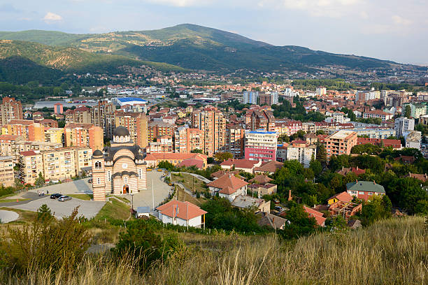 Mitrovice skyline in Kosovo A Serbian Orthodox church and apartment buildings dominate the view from a hill above the city of Mitrovica (Mitrovicë), in northern Kosovo. On the north side of city live mostly Serbs; to the south live mostly Albanian Kosovars. kosovo stock pictures, royalty-free photos & images