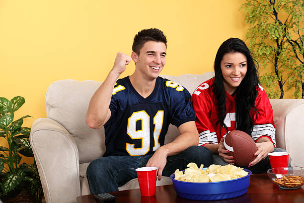 istock Watching Football Game At Home 186850114