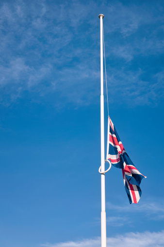 A British Union Flag flying at half mast.