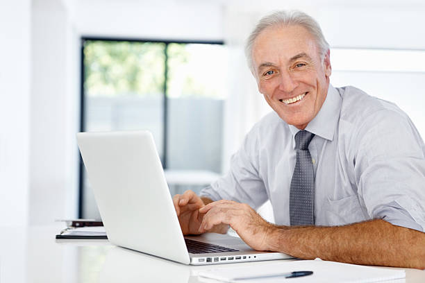 istock Smiling business man with laptop 186851722
