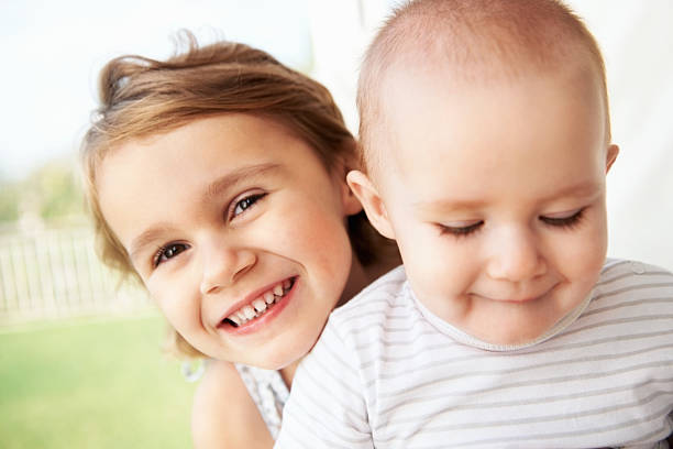 istock Cheerful girl with cute baby 186851728