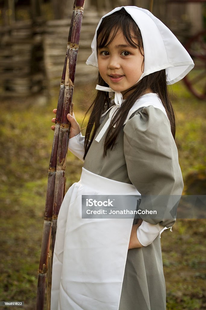 Young Puritan with Sugar Cane Cute five-year-old girl dressed as a 19th-century Puritan.Please see this slightly different version: Pilgrim Stock Photo