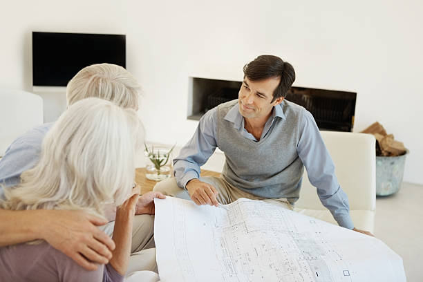 istock Architect discussing new home plan with a couple 186851883