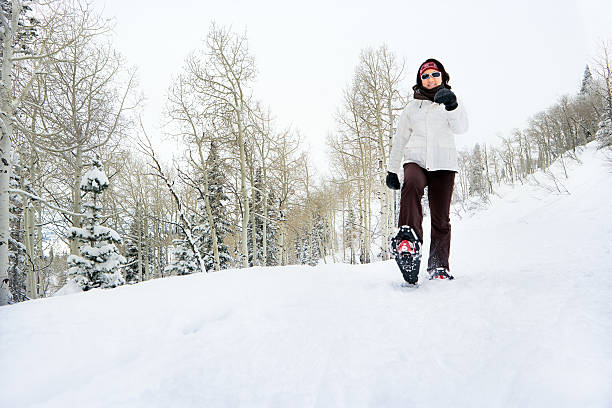 Young female enjoying snowshoeing.