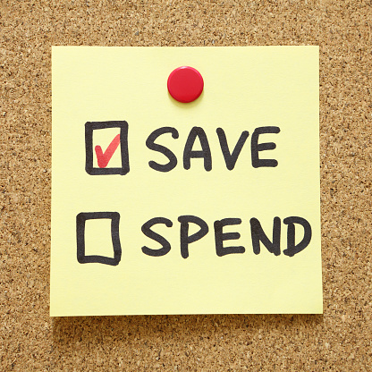 Save or Spend Checkbox on a post it note.