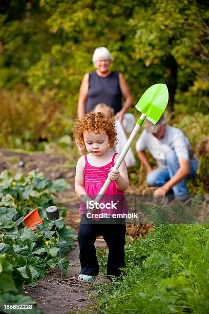 Girl Carrying Shovel In Garden Stock Photo - Download Image Now - Vegetable Garden, Child, Girls