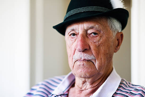 istock Serious old man in Tyrolean hat stares at camera 186852617