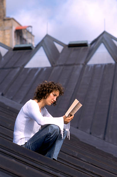istock Woman reading on rooftop. 186852726