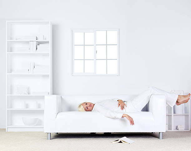 istock Woman resting on couch 186852831
