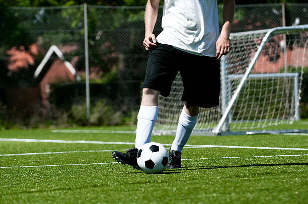 istock Soccer player and ball on the pitch 186852979