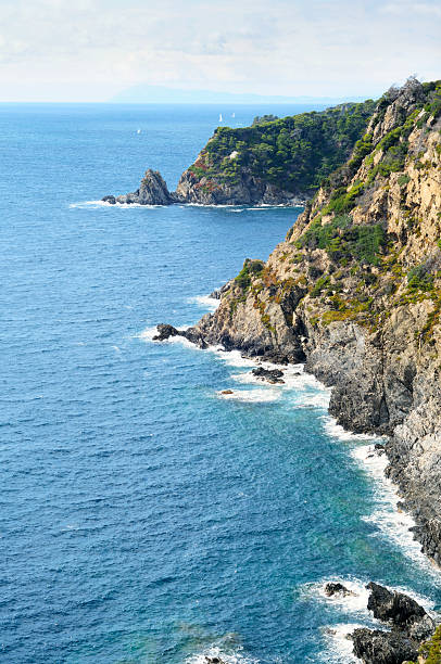 The little Mermaid statue on a rock of the island of Capri, bay of Naples, Italy.