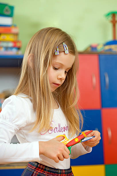 istock Little Girl With Scissors In School 186853521