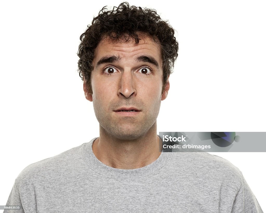 Confused, Surprised Man Raises Eyebrows Portrait of a man on a white background. Men Stock Photo