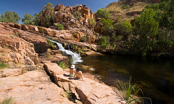 Champagne Springs Two hikers enjoying the tranquility of remote Champagne Springs on El Questro Station. kimberley plain stock pictures, royalty-free photos & images