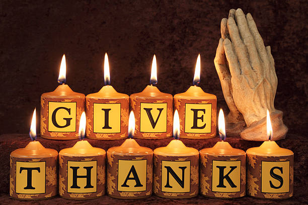 istock Give Thanks Candles with Praying Hands 186854263