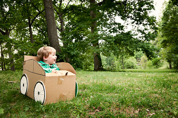 Little Boy in a Cardboard Car
