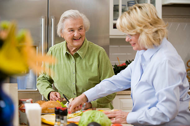 istock Smiling Senior Lady with a friend in a kitchen 186854421
