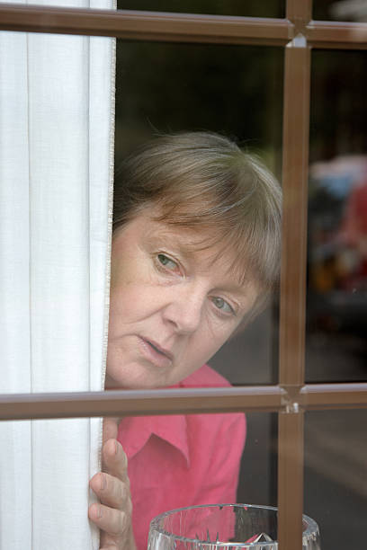 istock Nosey neighbour at the window 186854495