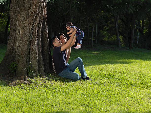 istock Young family sitting at the park 186854540