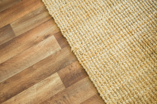 Wooden floor and rug background image. Space for copy.