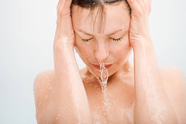 young woman having a shower close up portrait of young woman having a shower shower women falling water human face stock pictures, royalty-free photos & images