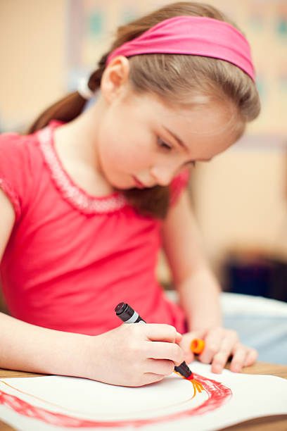 istock Girl Student Drawing a Picture at School 186854709