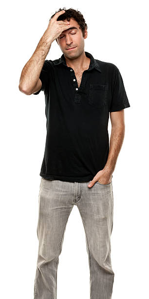 Stressed Man Rubs Forehead Portrait of a man on a white background. http://s3.amazonaws.com/drbimages/m/doncam.jpg worried man standing stock pictures, royalty-free photos & images