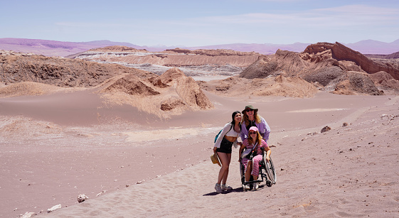 San Pedro de Atacama, Chile - October 26. wheelchair user having  Being Impressed with Fantastic Landscape of the Moon Valley or Valle de la Luna in Atacama Desert of Chile