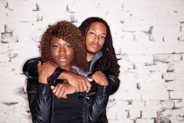 istock Young black couple standing in front of brick wall 186855234