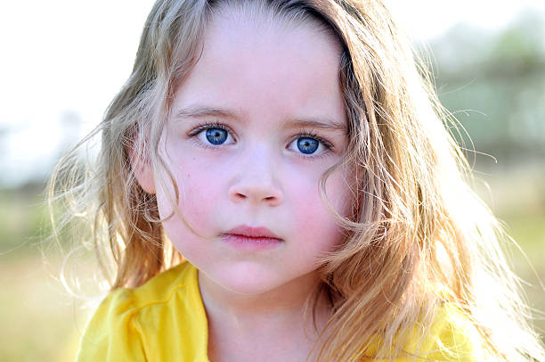 istock Beautiful young girl with a serious expression outside 186855532