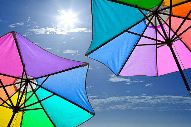 istock Rainbow-colored Beach Umbrellas and Sunny Sky 186855645