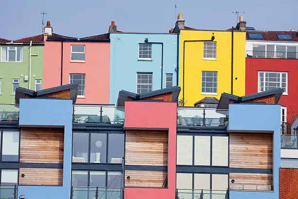 Colourful Georgian houses at Hotwells Bristol with the modern 21st century version built in front of them.