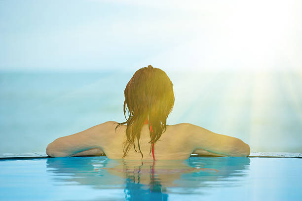 istock Woman relaxing in blue pool 186856099