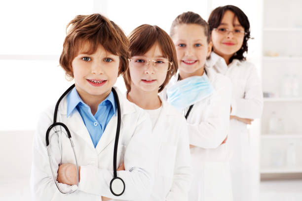 istock Little smiling doctors standing in a row at workplace. 186856171