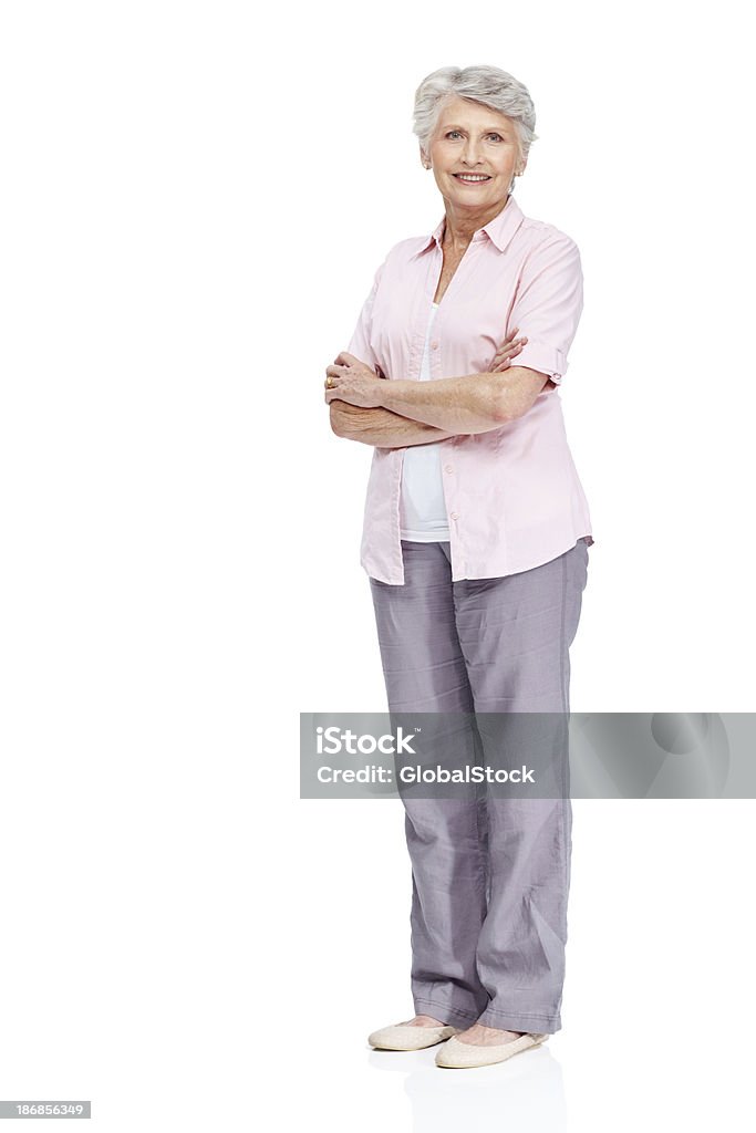 Respected member of the senior citizen community "Attractive senior woman smiling at the camera with arms crossed, isolated on white - copyspace" Senior Women Stock Photo