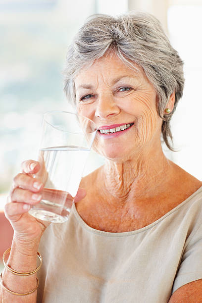 Senior woman drinking water