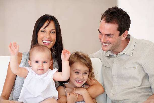 happy family in jeans sitting on white