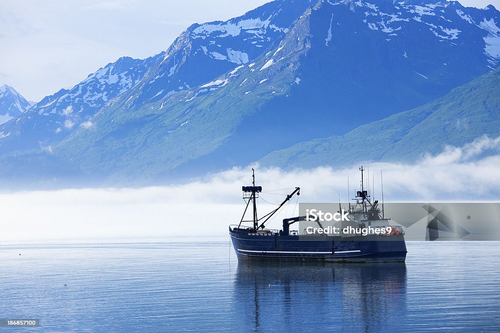 Large fishing boat anchored in Valdez, Alaska bay "Large fishing boat anchored in Valdez, Alaska bay. Chugach Mountains in background." Fishing Industry Stock Photo