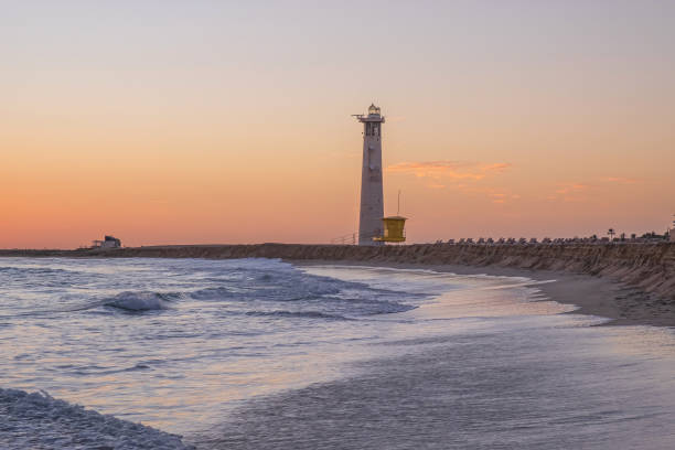 istock View on the lighthouse, the ocean waves and the beach at sunset with beautiful colours in Morro Jable, Jandia on the Canary Island Fuerteventura, Spain. 1868572995