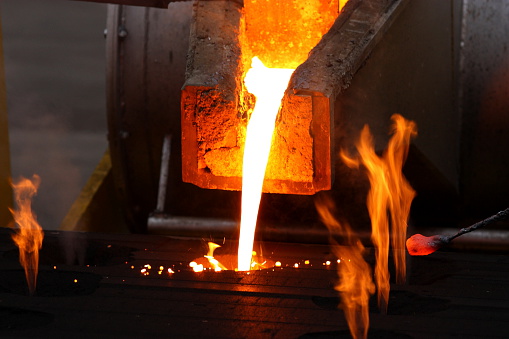 Molten metal poured from lathe for iron casting.
