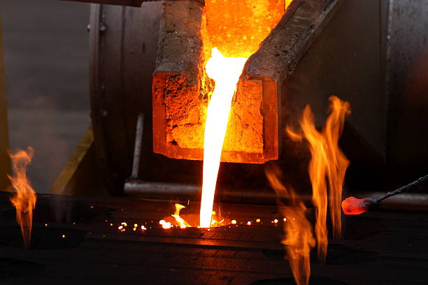Foundry Molten metal poured from lathe for iron casting. melting metal stock pictures, royalty-free photos & images