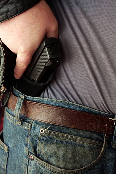 istock Concealed Carry Firearm Drawn From an Inside-the-Waistband Holster 186857695