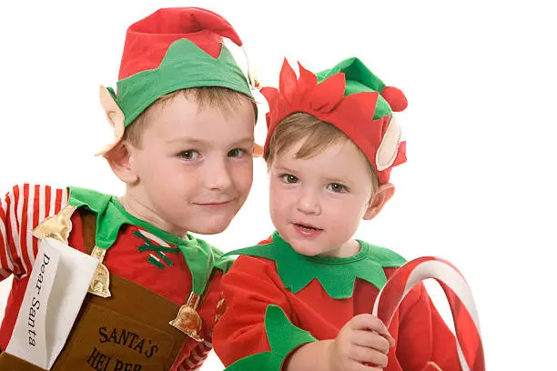 Two little Christmas elves isolated on white.
