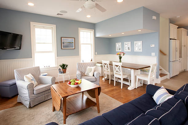 Seaside house interior, living room An open floor plan interior of a beach house. Living room and kitchen nook both leading into a galley kitchen and the stairwell bringing you to the three bedrooms. breakfast room stock pictures, royalty-free photos & images