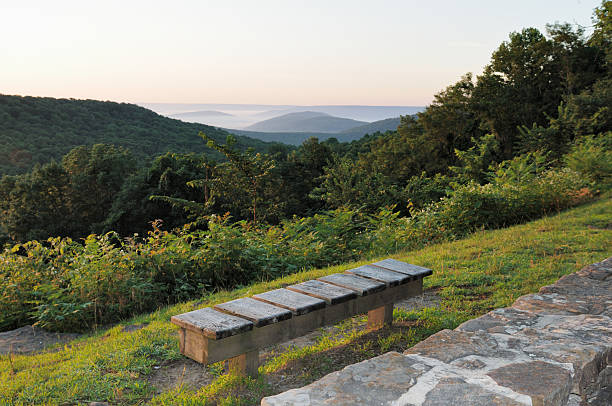 istock Bench on mountain top at sunrise or sunset 186858109