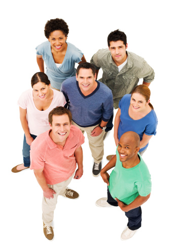 Group of young adults in colorful shirts stand together and smile up at the camera. Vertical shot. Isolated on white.