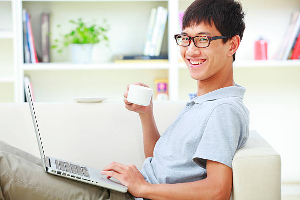 istock young asian man surfing the net in home 186858478