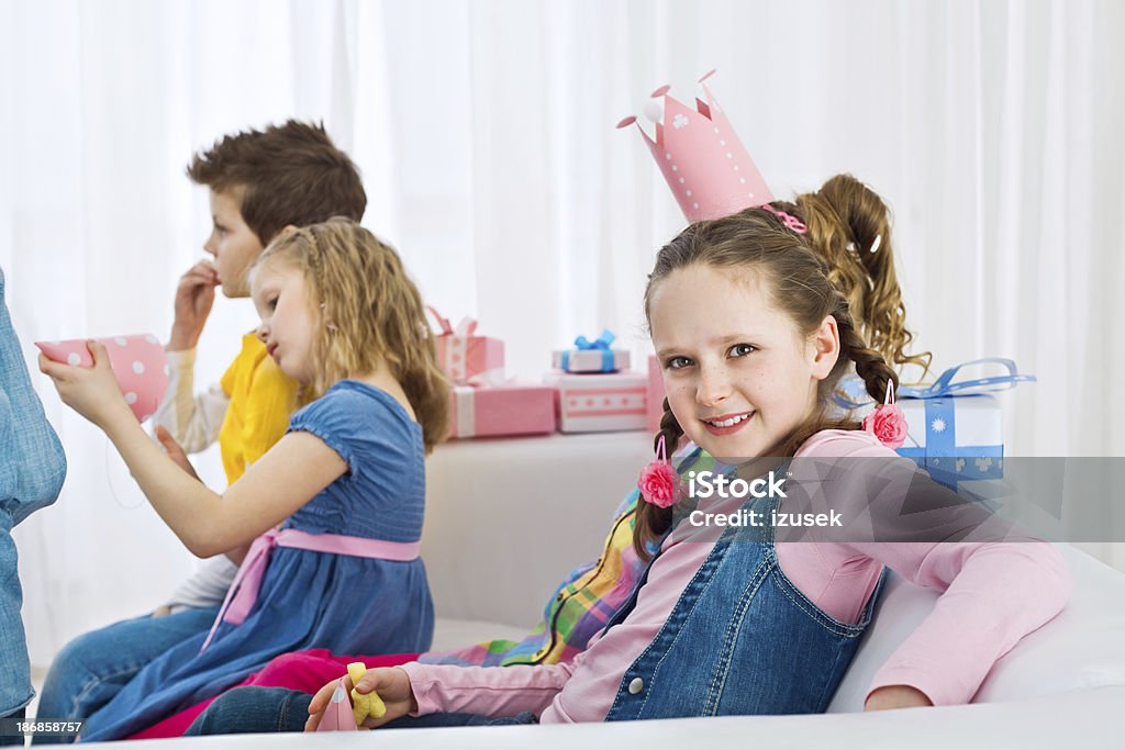Cute girl at birthday party Children celebrating at a birthday party. Focus on a cute little girl looking at camera and smiling. 6-7 Years Stock Photo